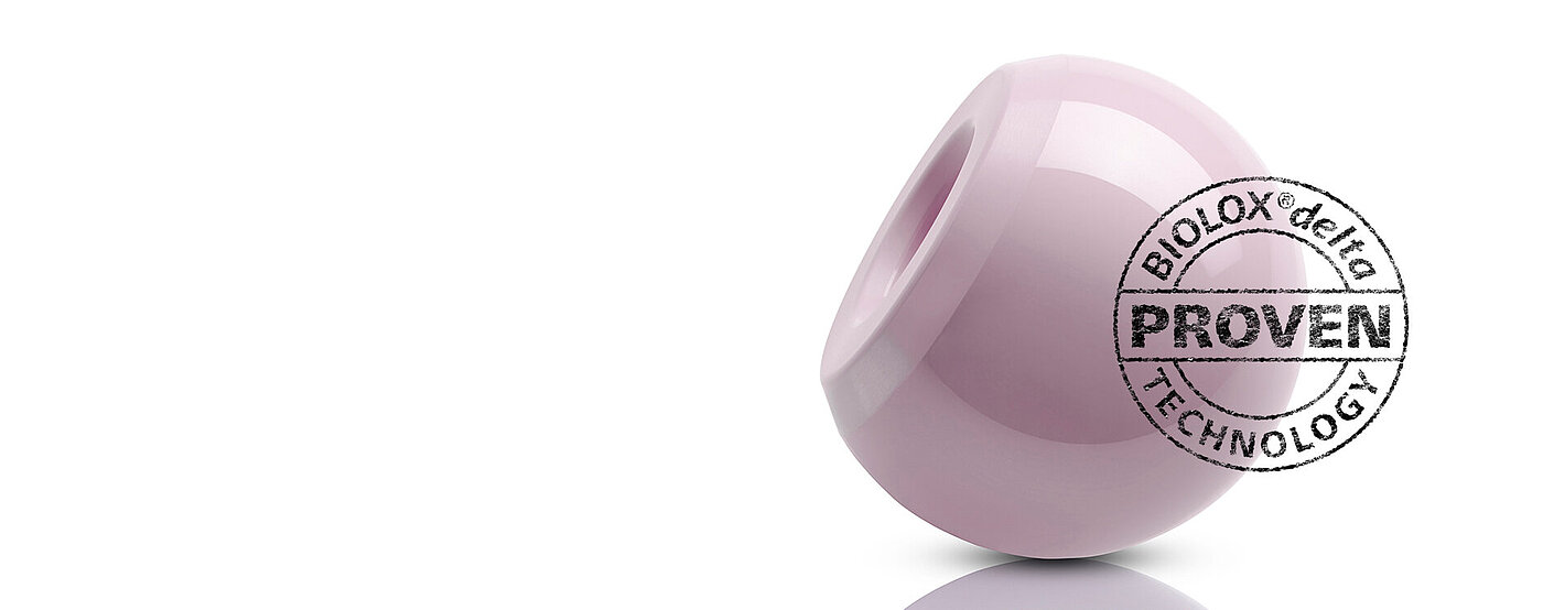 Image of a pink ceramic bearing used in hip replacement, a stamp on the image reads ‘BIOLOX®delta PROVEN technology’
